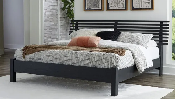 The Signature Design by Ashley Danziar collection panel bed with bedding and décor 