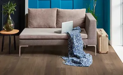 The COREtec Premium Midnight collection vinyl flooring with a sofa and décor 