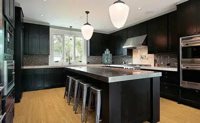 The COREtec Rocky Mountain collection vinyl flooring in a black-themed kitchen
