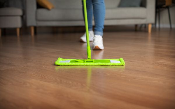 A person mopping wooden floors