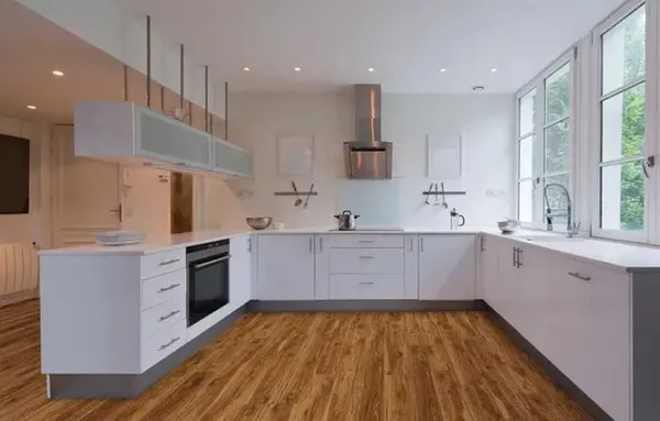 The COREtec Classics collection vinyl flooring in a midway oak finish in a modern kitchen 