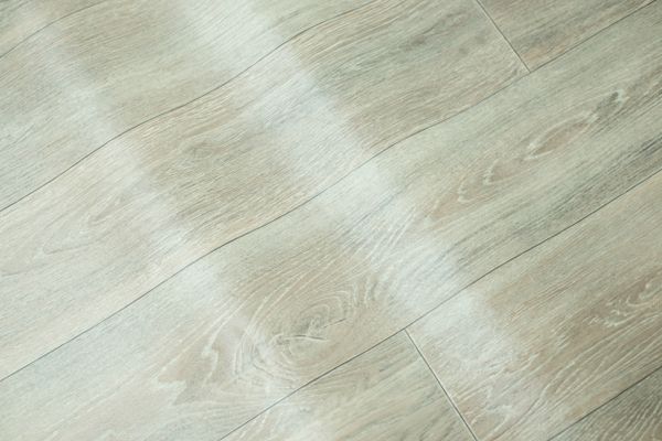 A close-up of warped vinyl flooring 