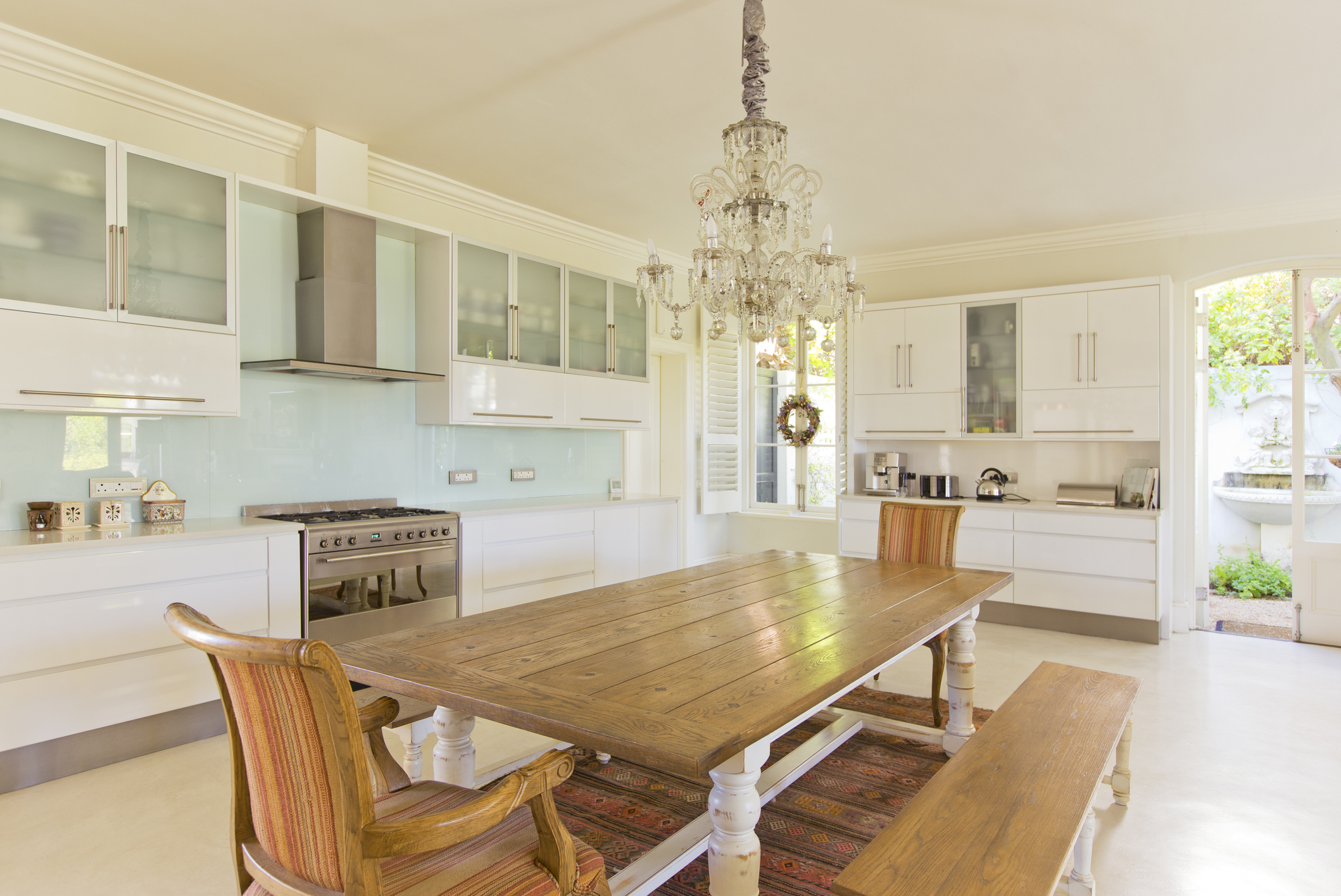 A wooden farmhouse dining table with bench in a farmhouse kitchen 