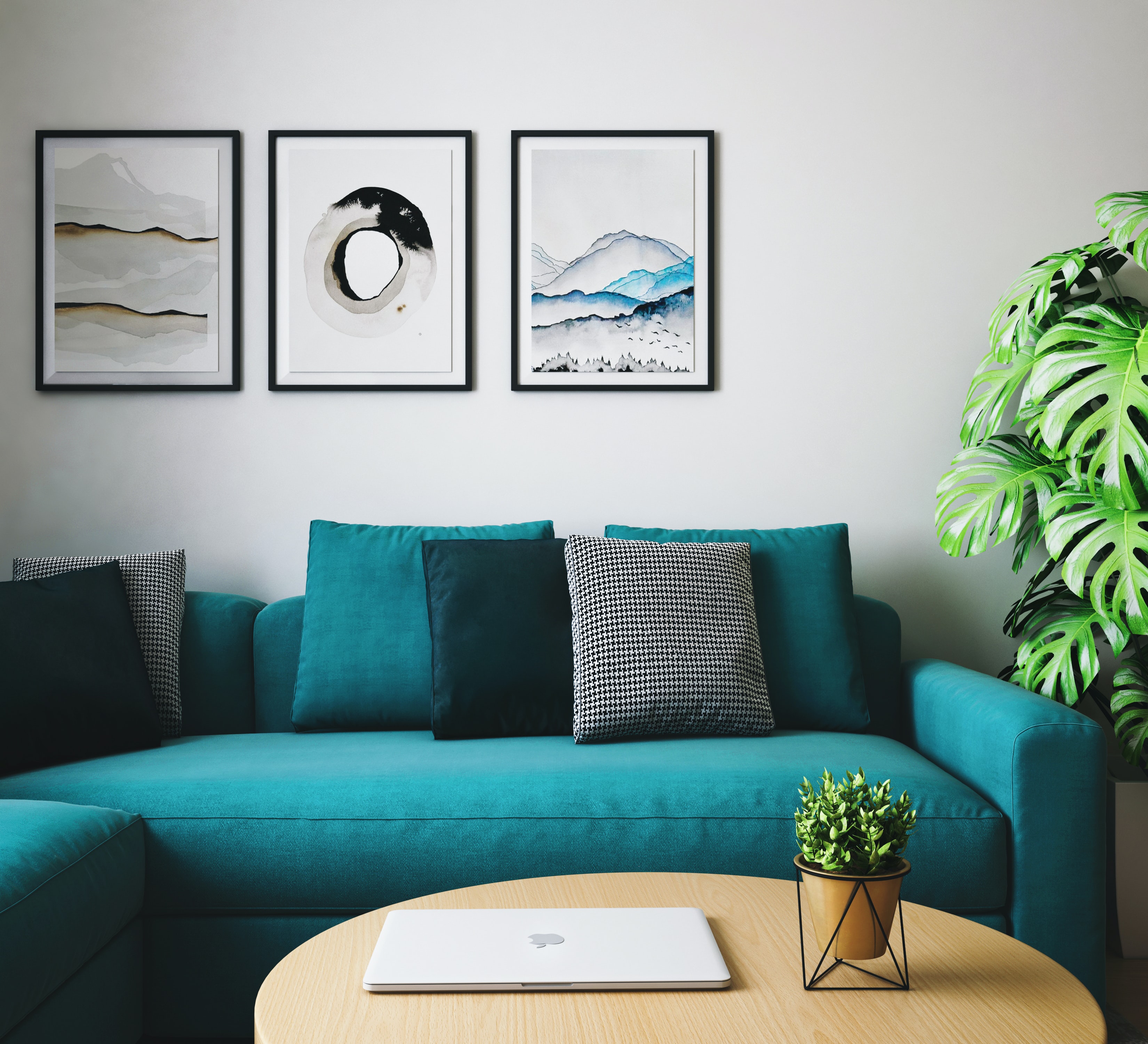 A teal L-shaped sectional with multi-pattern pillows 