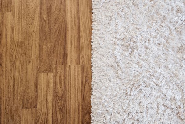 A side by side comparison of hardwood and carpeting
