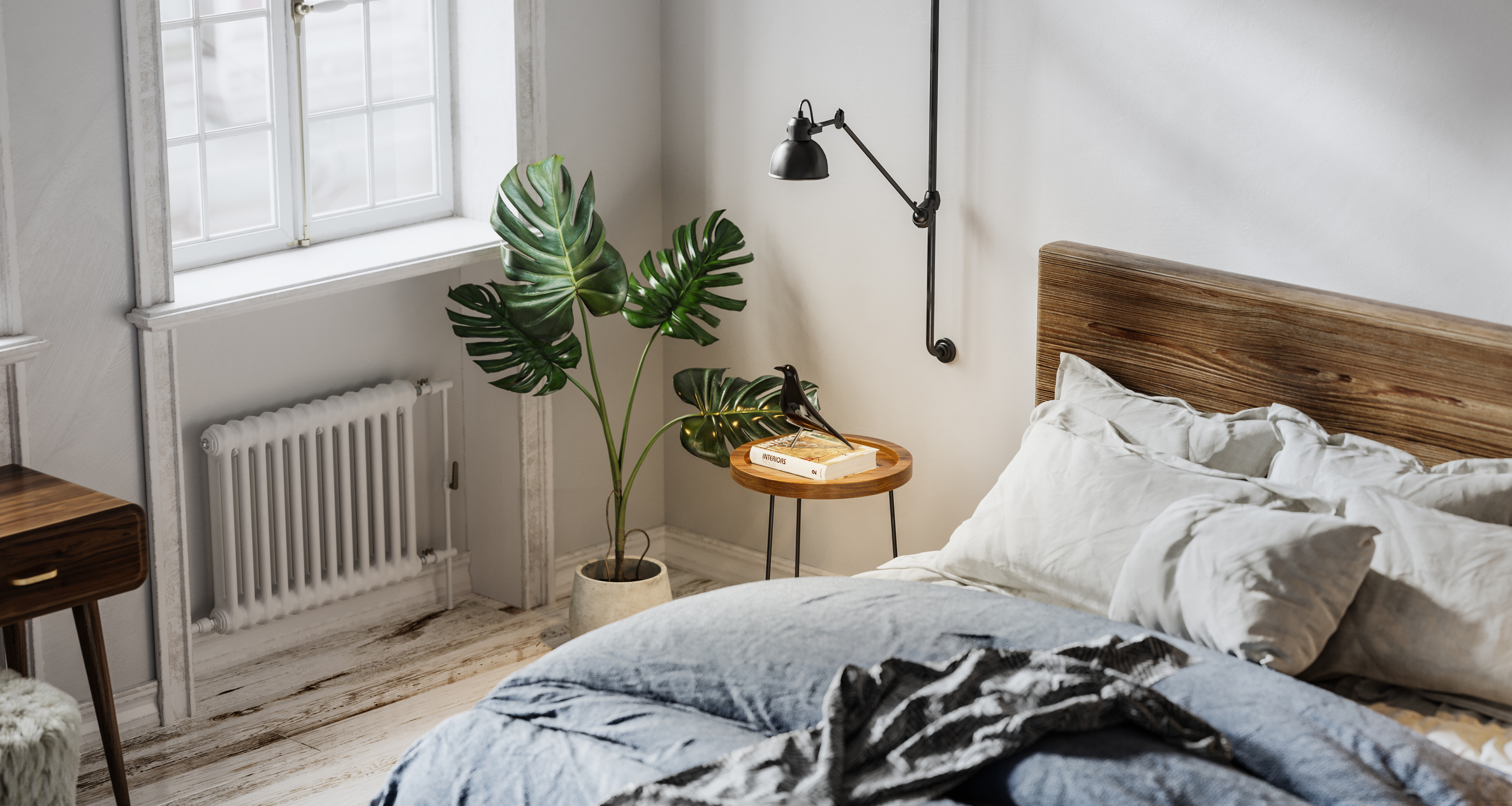 A wooden bed with a plant and bedside table 