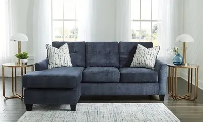 Front view of the Benchcraft Amity Bay collection sofa with décor 
