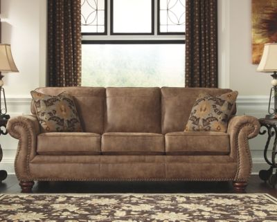 Front view of the Signature Design by Ashley Larkinhurst collection sofa with decor