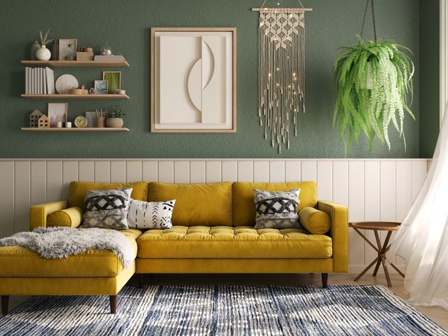 Front view of a modern boho living room with green walls and a yellow sectional