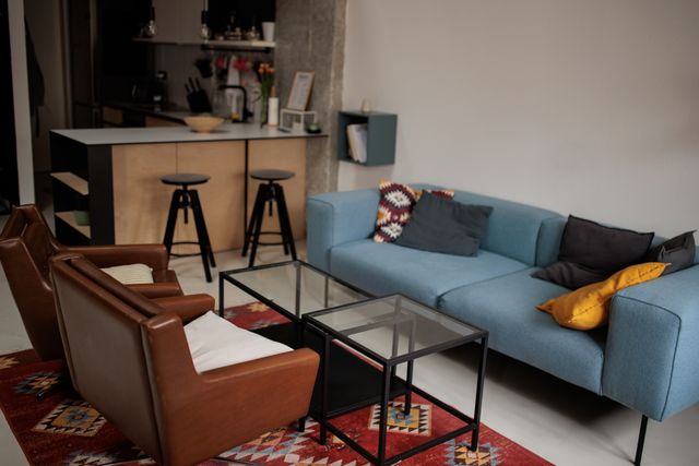 Front view of a modern apartment living room and kitchen with modern and contemporary furniture