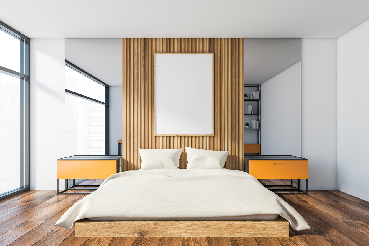 brown wall with clean bed and 2 side tables