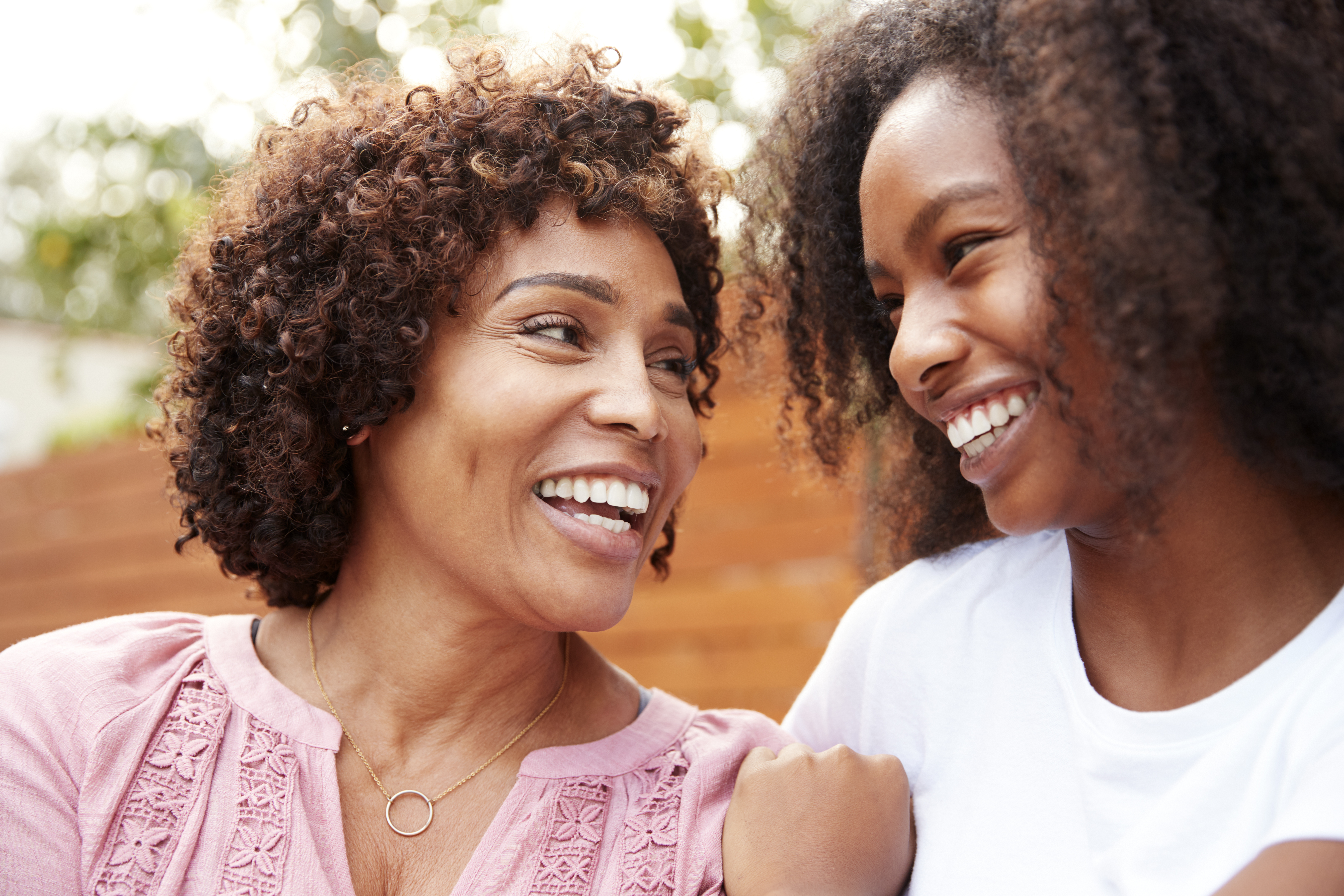 African American mother and daughter smiling together 