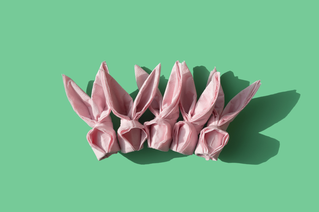 pink origami paper napkins on a seafoam background