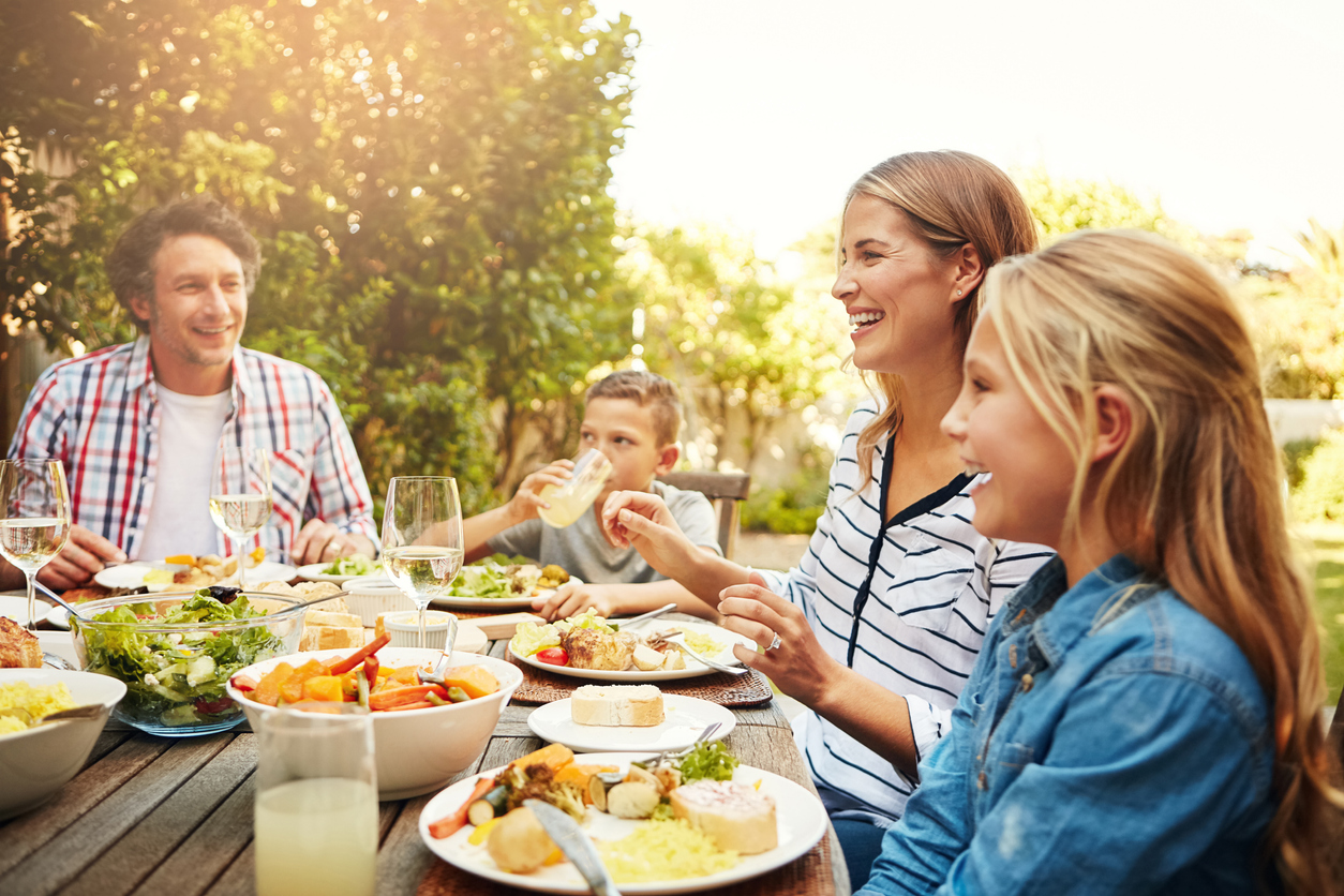 family eating lunch together outdoors
