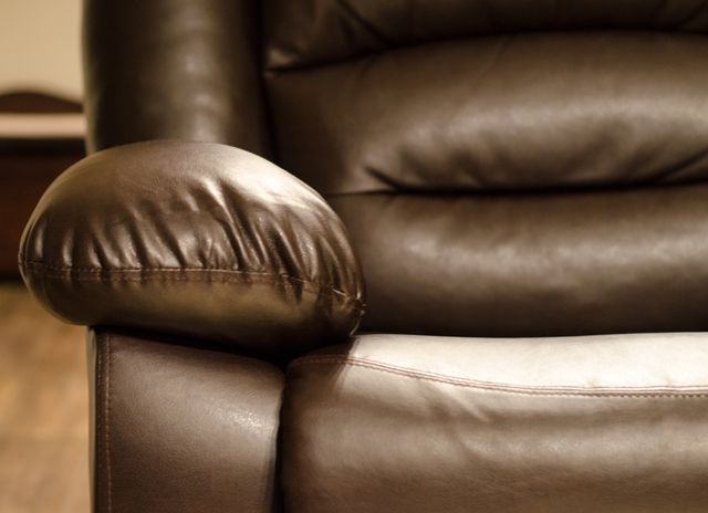 close view of a brown leather recliner arm