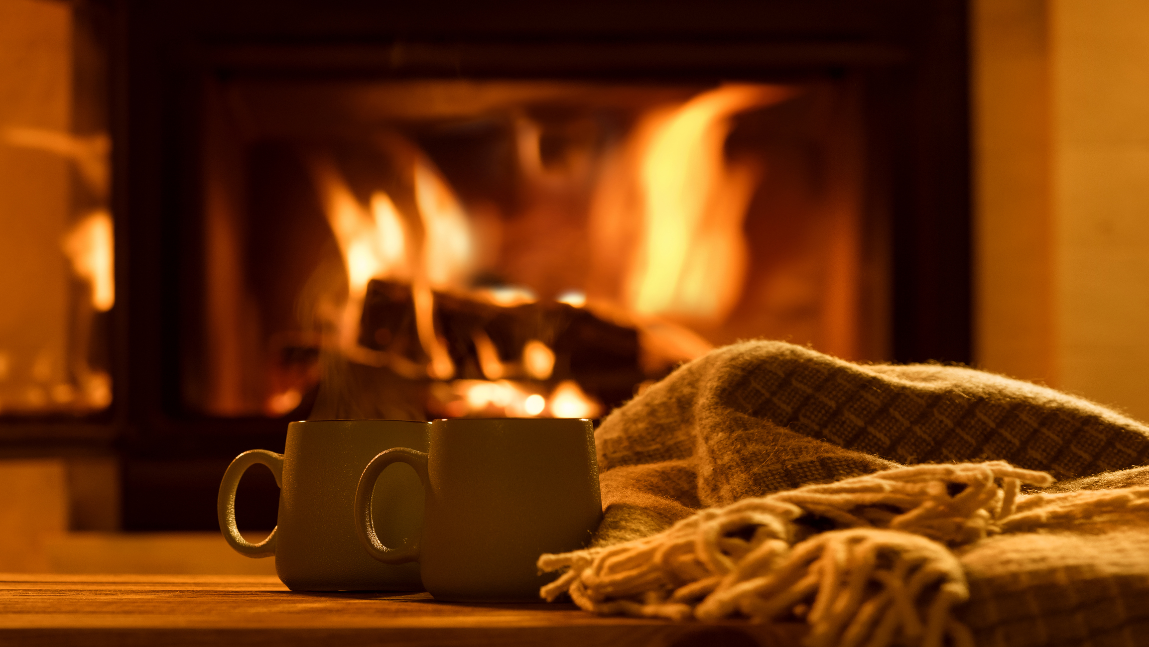 roaring fire with blankets and hot cocoa