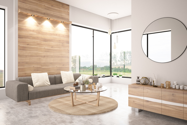 mid-century modern living room staged with wall lighting and round mirror