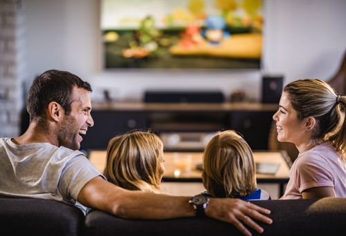 Family Enjoying Home Entertainment System