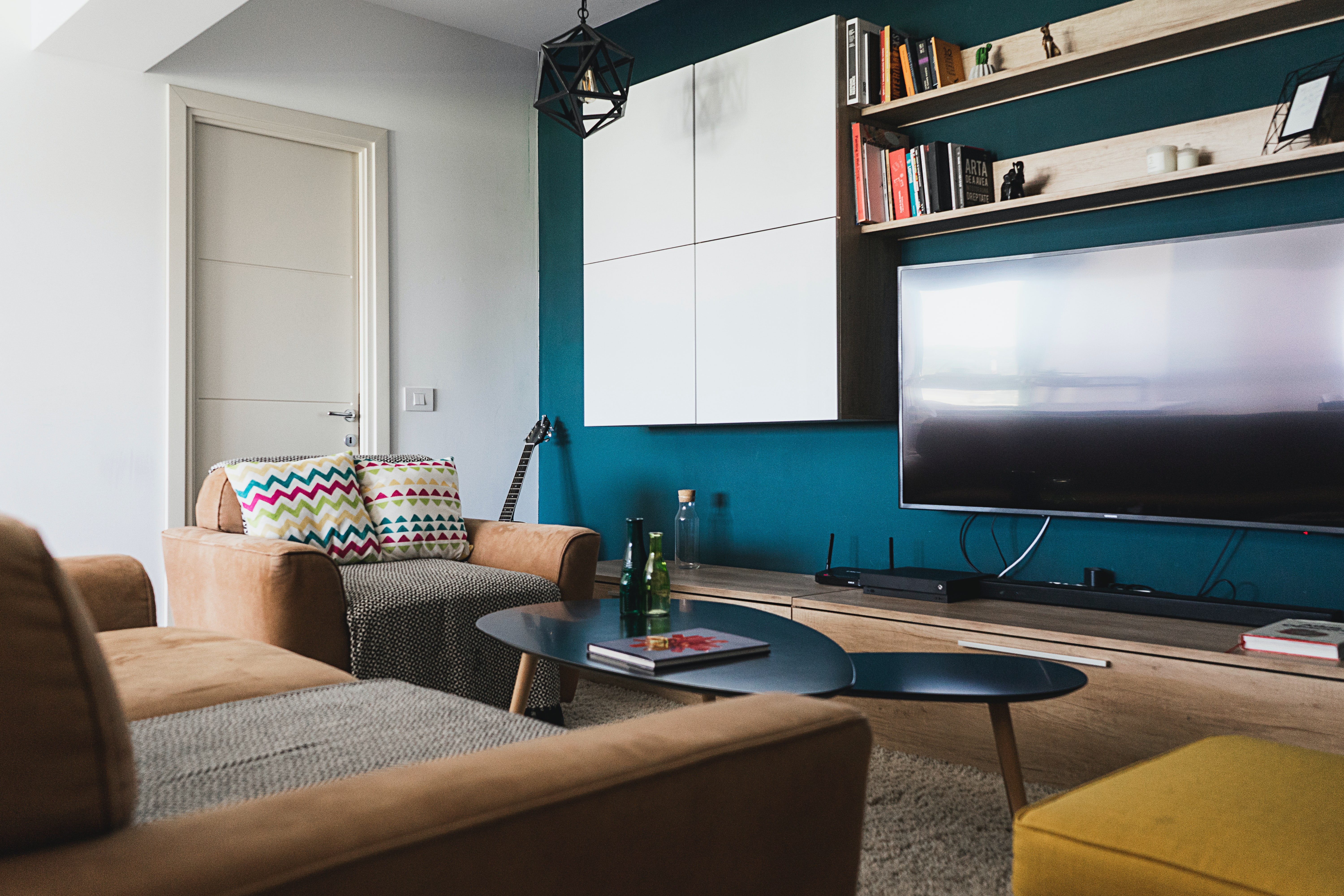 modern home theater replete with suede armchair and loveseat