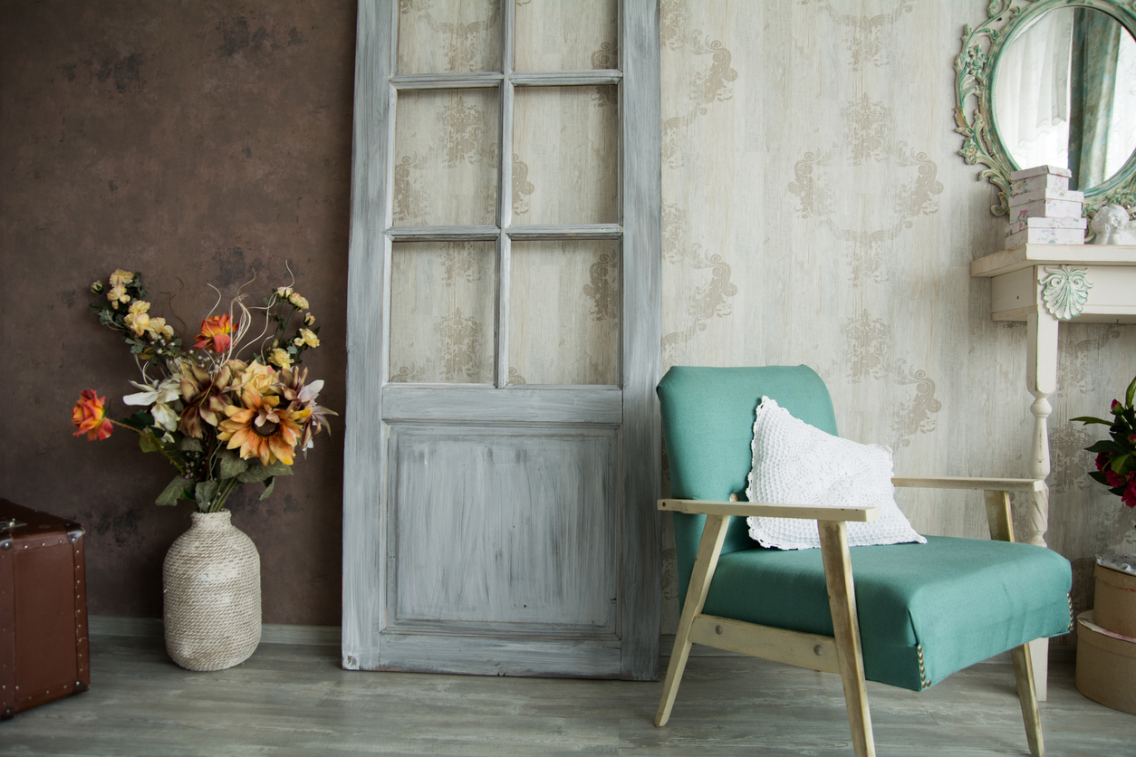 Shabby chic style room with accent chair and flower pot