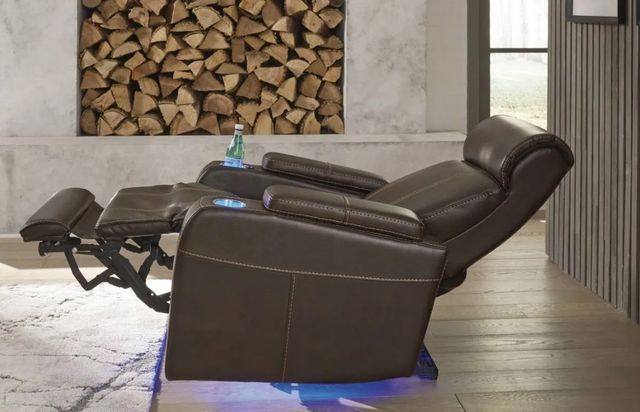 side view of a Signature Design by Ashley Recliner fully reclined in a modern space