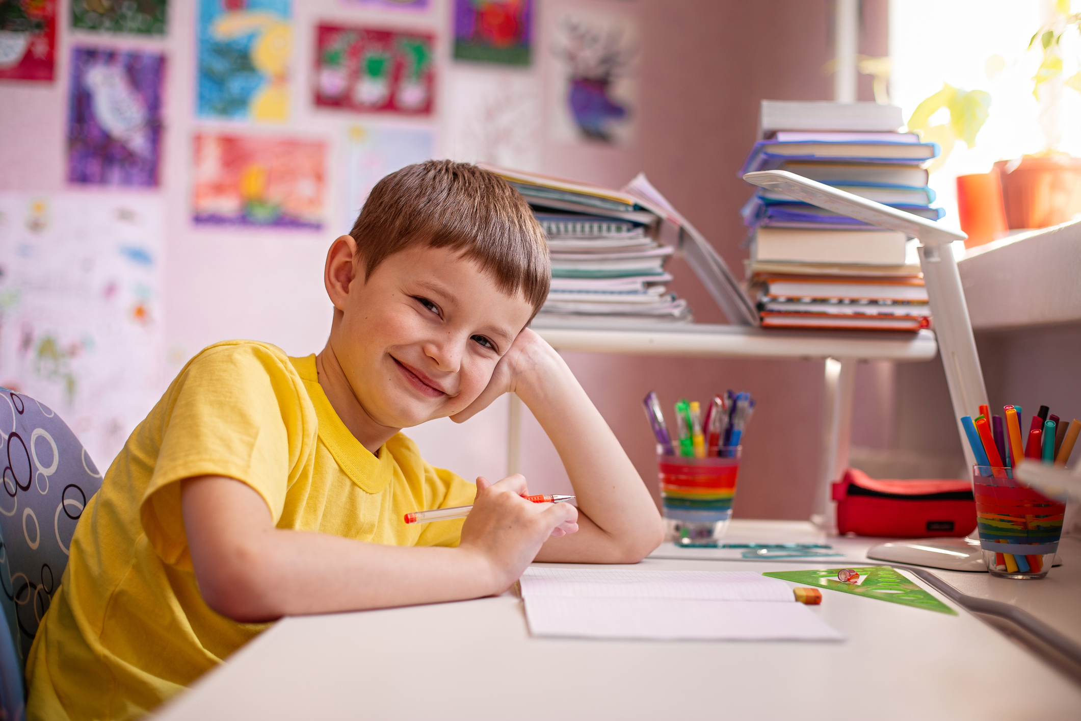 young boy studying in his room