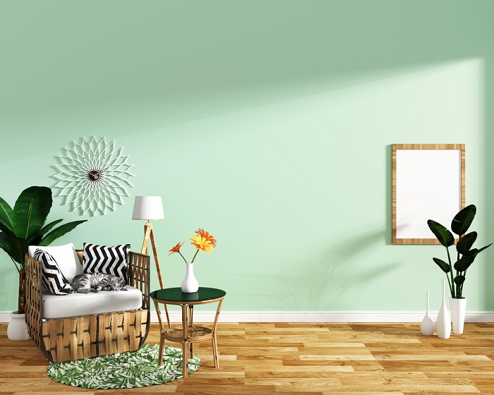 Tropical interior living room setup with light green wall. 