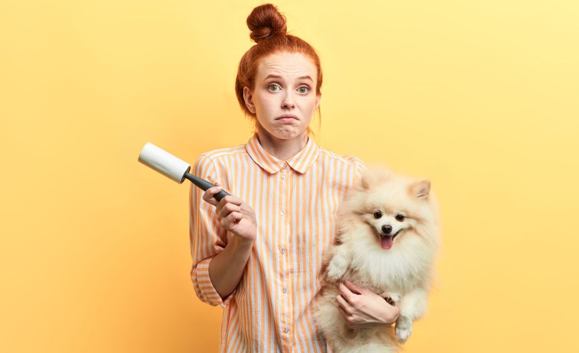 Woman Holding Dog with Lint Roller
