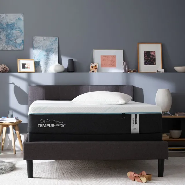 a mattress on a bedframe in a room