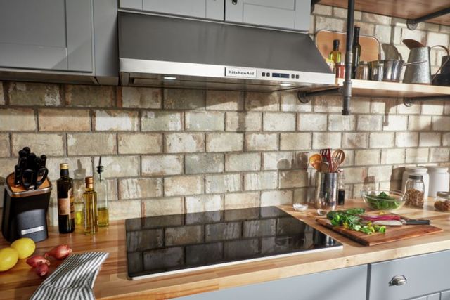 A Kitchenaid range hood above a Kitchenaid 30 inch electric cooktop