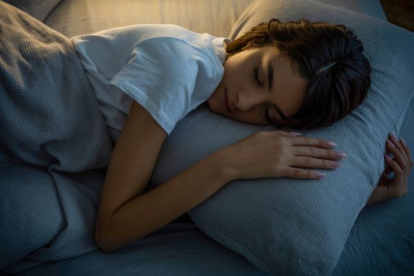 A close-up of a woman sleeping on her side