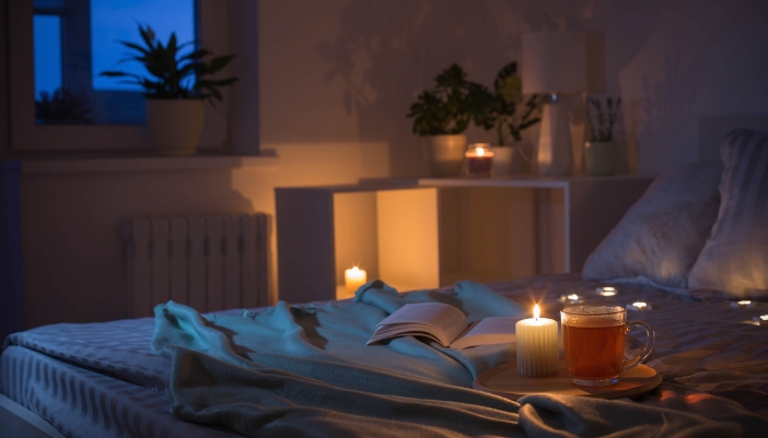 Bed with a book and other sleep-helping accoutrements