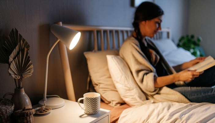 Woman reading in bed before going to sleep
