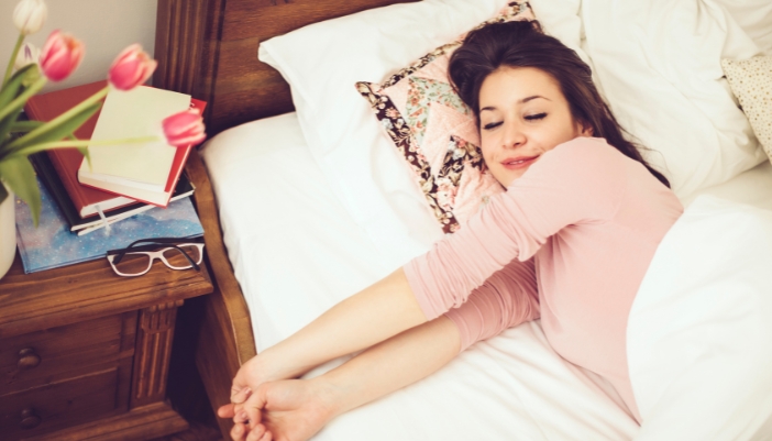 Woman having sleep dreams before waking up in the morning