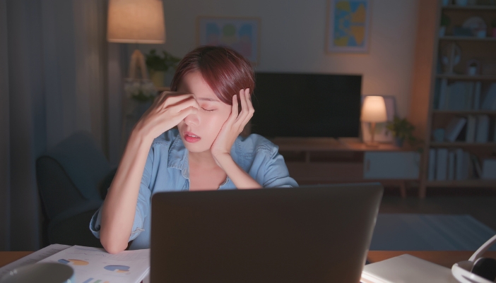 Woman staying up late working on something