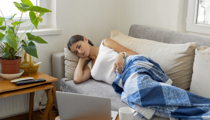 Woman taking a power nap on the couch after working