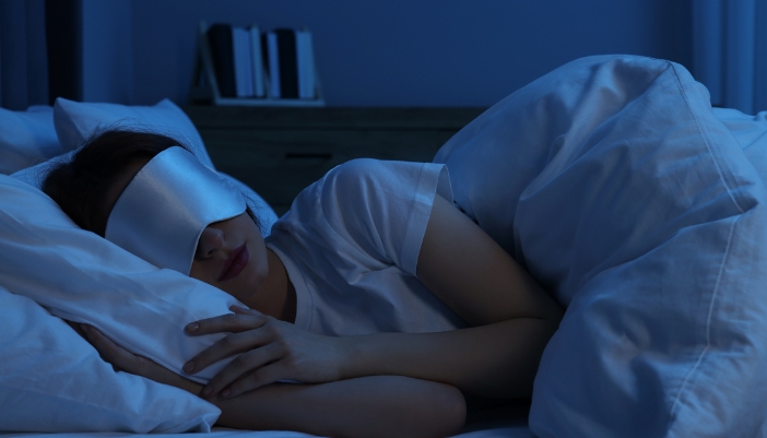 Woman with an eye mask sleeping peacefully