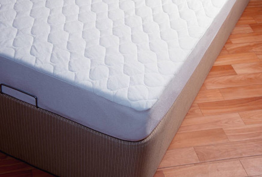 front close view of a modern box spring foundation with a thin white mattress on top