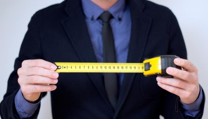 Man holding pulled out measuring tape