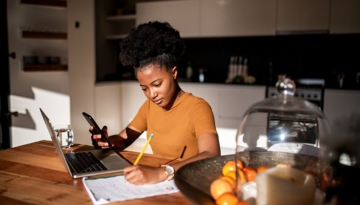woman doing work in kitchen while in the sun