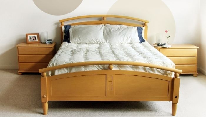 Fully made-up bed with nightstands on both sides
