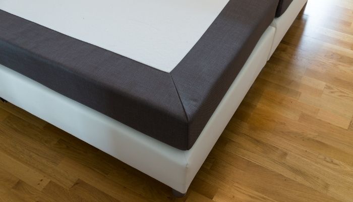 View of the corner of a box spring on a frame