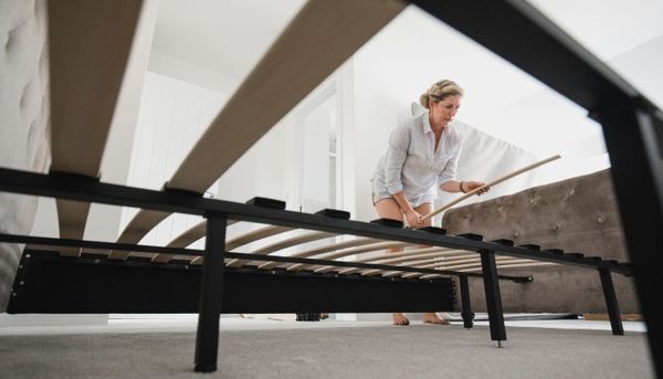 low view of a woman building a mattress foundation