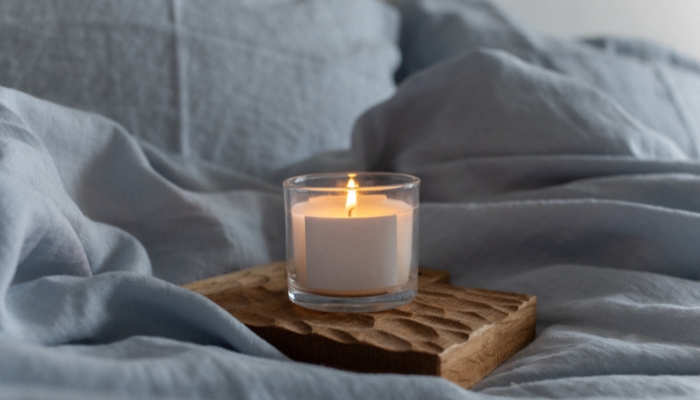 Candle sitting on top of bed