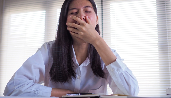 Woman feeling sleepy in the daytime while working
