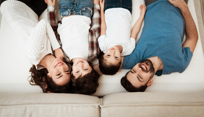Family testing a mattress in store