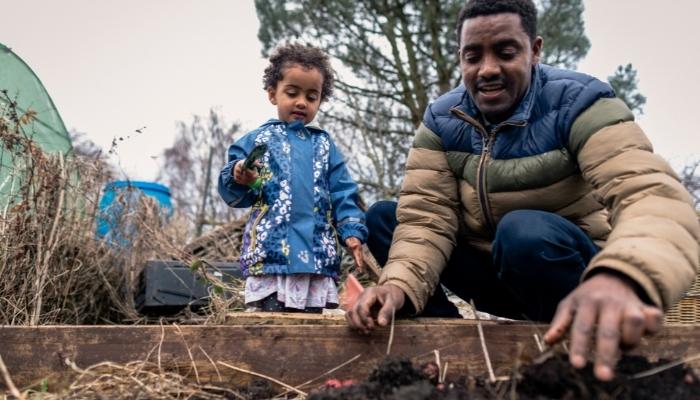 Father and son digging in garden