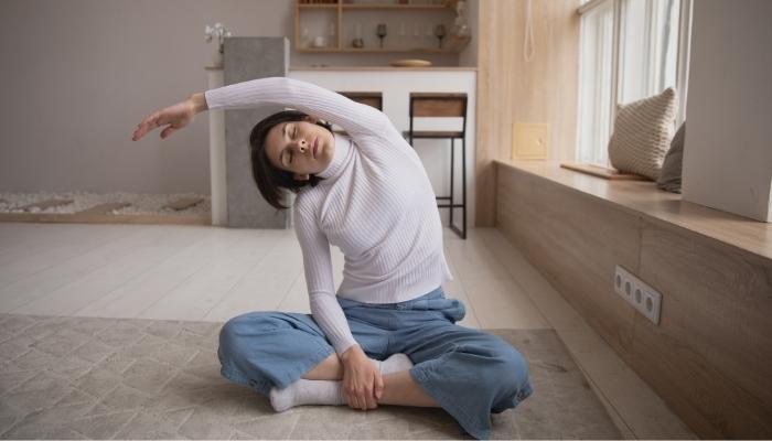 Woman stretching while sitting