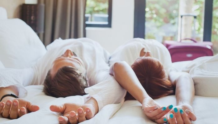 guests relaxing on the bed in their room