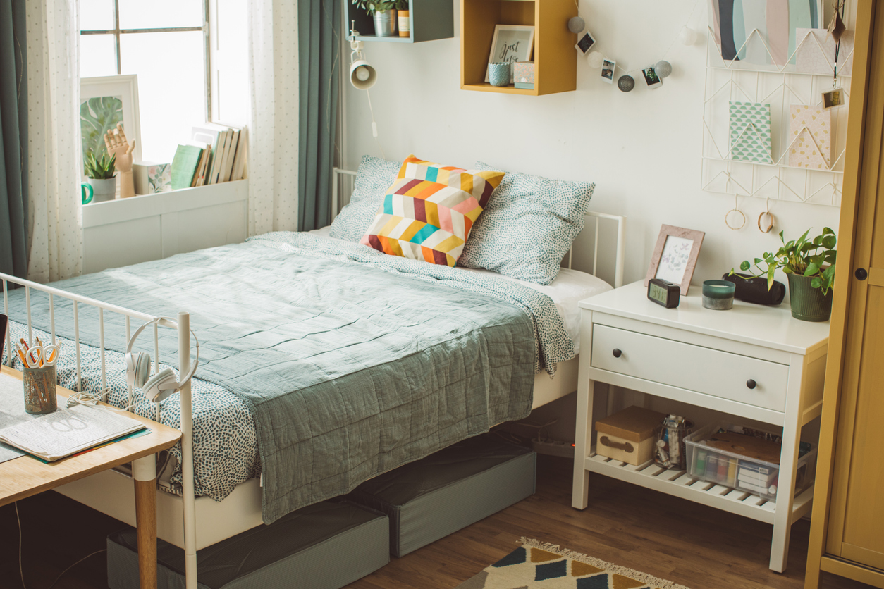 trendy college dorm room with bed, nightstand, and desk